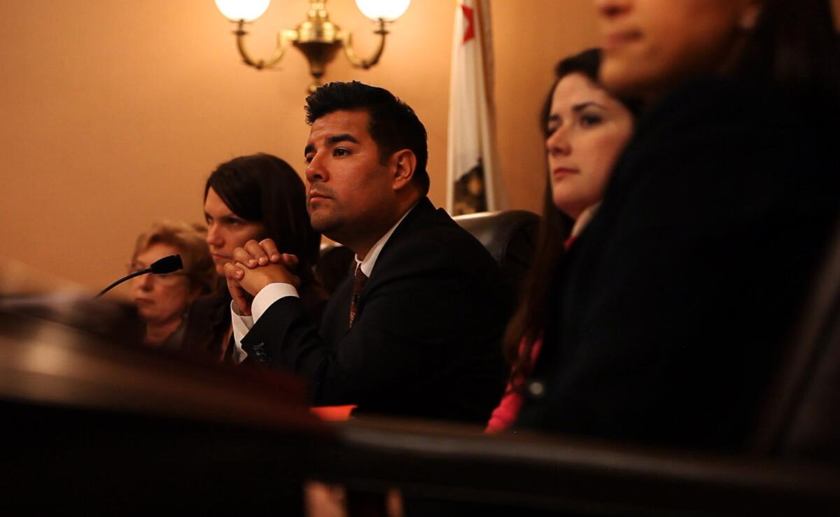 State Sen. Ricardo Lara (D-Bell Gardens), shown at a recent hearing, won approval Monday of a bill banning political fundraisers at the homes and offices of Capitol lobbyists.