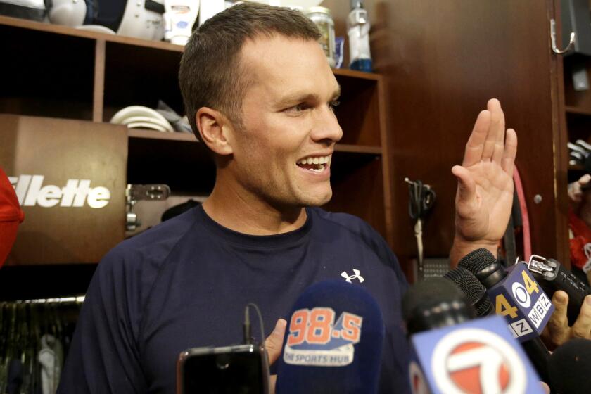 Patriots quarterback Tom Brady speaks to reporters in the locker room before a practice Wednesday.