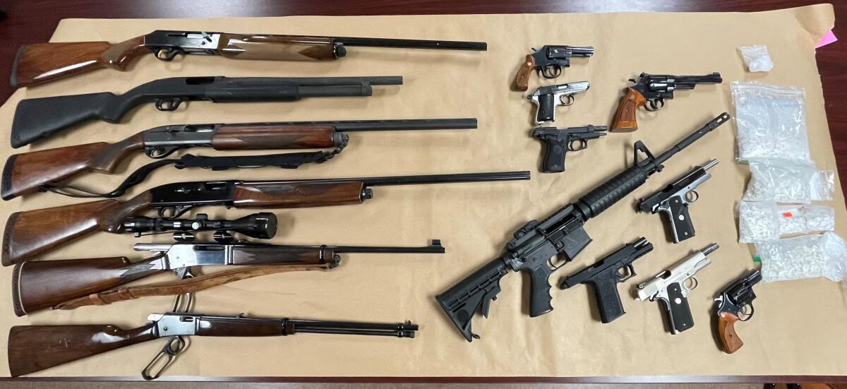Fountain Valley police seized more than $22,000 of narcotics and 15 firearms during a drug bust Monday.