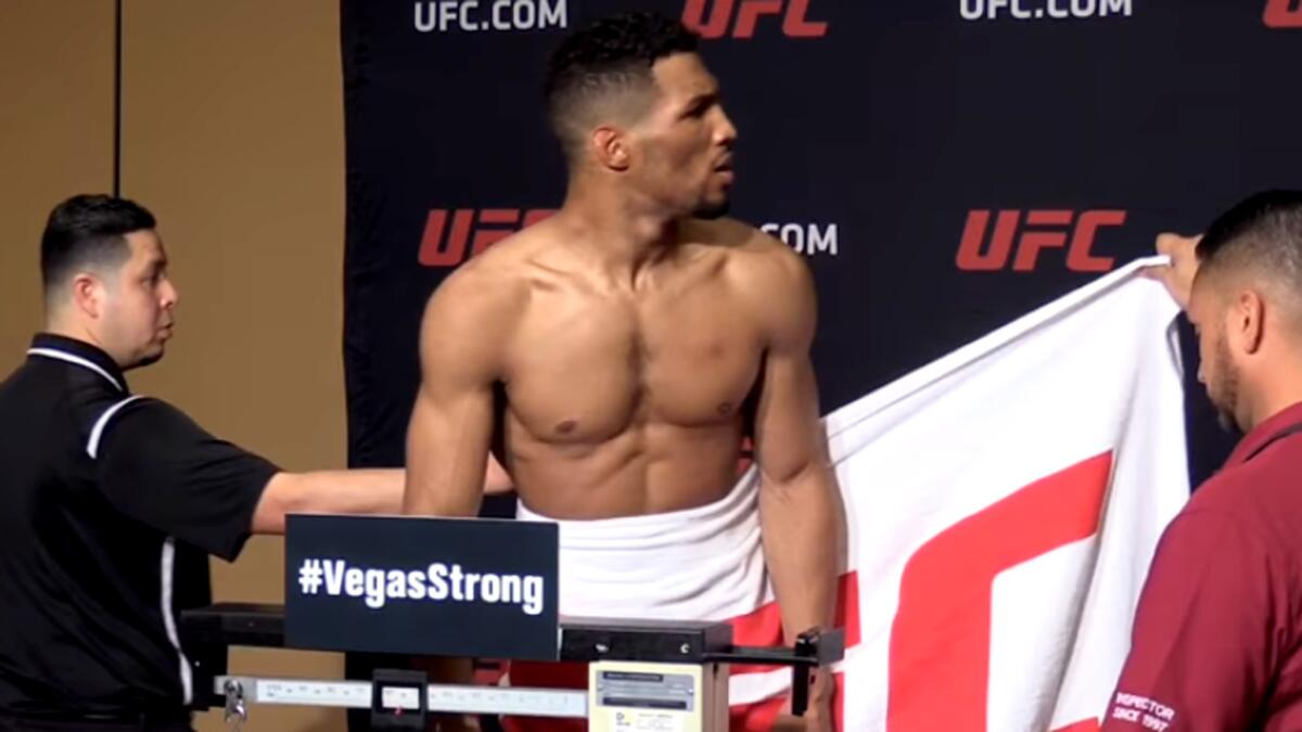 Kevin Lee reacts after hearing he's one pound over the lightweight limit for his UFC interim title fight. He would make weight with a one-hour extension.
