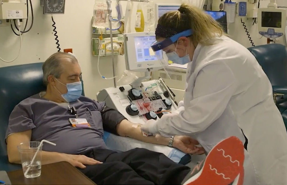 A man who recovered from COVID-19 donates plasma.