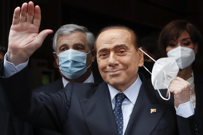 FILE - Former Italian Premier Silvio Berlusconi waves to reporters as he arrives at the Chamber of Deputies to meet Mario Draghi, in Rome, on Feb. 9, 2021. Former premier Silvio Berlusconi has bowed out of Italy’s presidential election set for next week. Berlusconi, 85, said in a statement on Saturday that he had decided to “take another step on the path of national responsibility.” The media mogul insisted he had nailed down enough voters to become head of state, but he asked his supporters not to cast ballots for him. (AP Photo/Alessandra Tarantino, File)