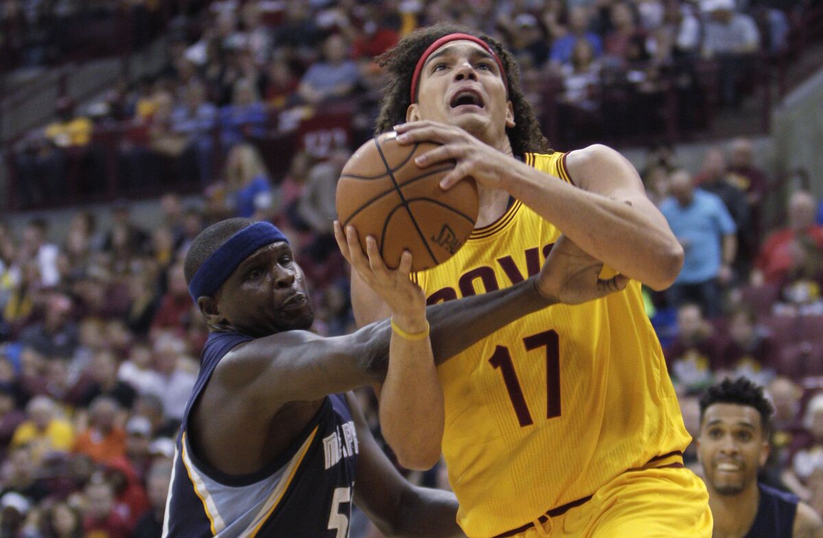 FILE - In this Oct. 12, 2015, file photo, Memphis Grizzlies' Zach Randolph, left, fouls Cleveland Cavaliers' Anderson Varejao during the first quarter of an NBA preseason basketball game in Columbus, Ohio. The Cavaliers have considered re-signing former center Varejao for the remainder of the season, a person familiar with the team's thinking told the Associated Press on Friday, April 30, 2021. (AP Photo/Jay LaPrete, FIle)