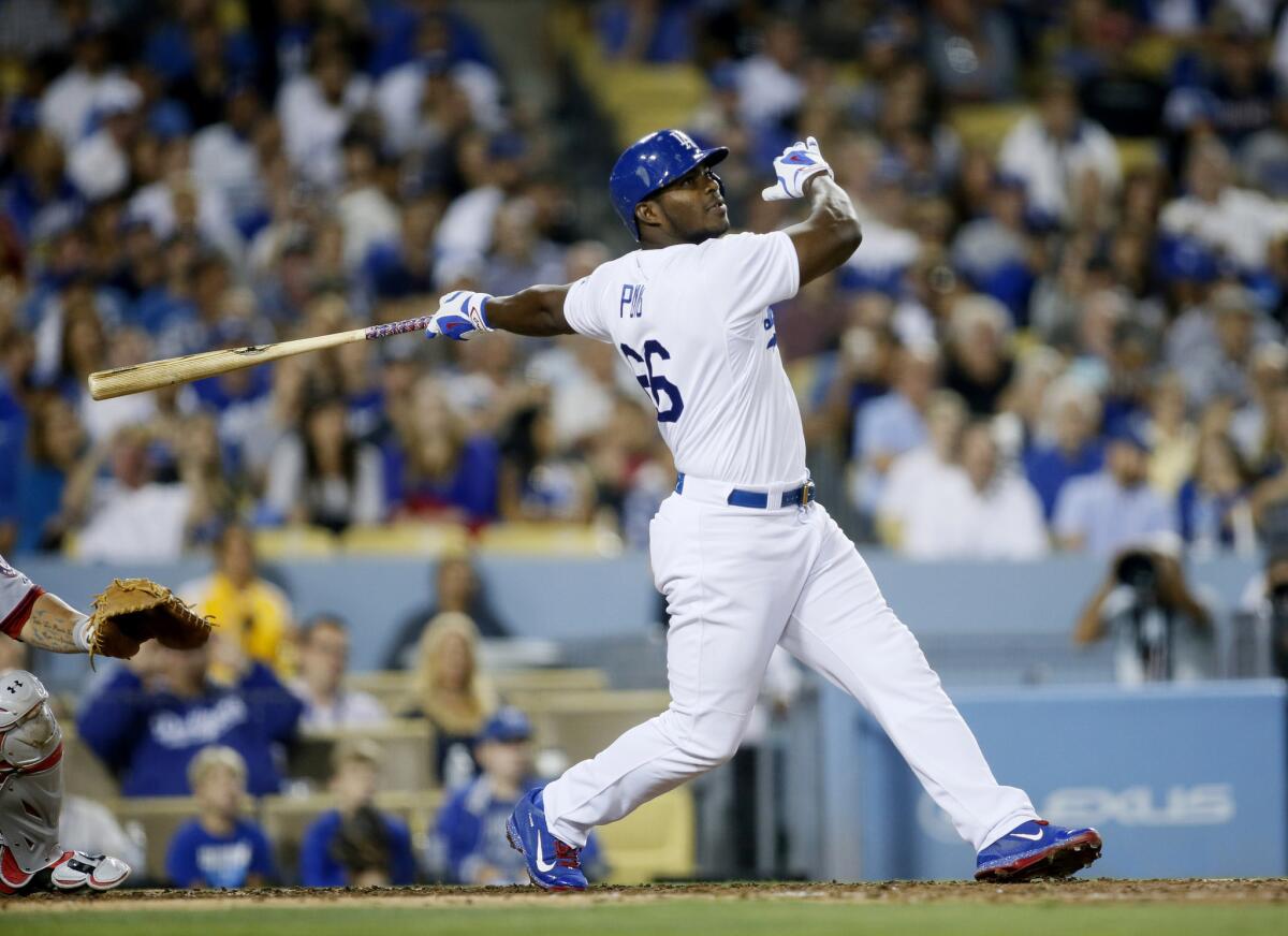 Dodgers right fielder Yasiel Puig follows through on a three-run triple to right field against the Nationals in the fifth inning on Aug. 11.