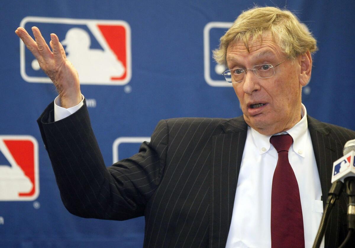 Baseball Commissioner Bud Selig talks with reporters after a meeting with team owners in Chicago.