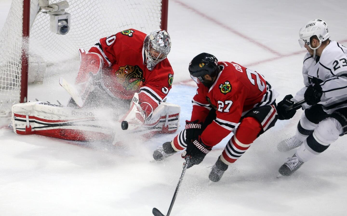 Blackhawks goaltender Corey Crawford makes a save on a shot by Kings left wing Dustin Brown in the third period of Game 2 at United Center in Chicago.