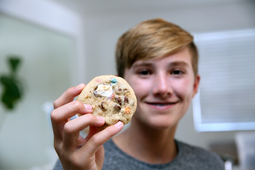Jasper Rogers poses with his signature Sea Monster cookie.