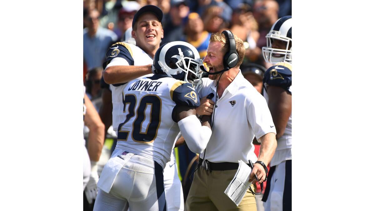 Rams quarterback Jared Goff and head coach Sean McVay celebrate with safety Lamarcus Joyner after Joyner intercepted a Colts pass for a touchdown in the 3rd quarter.