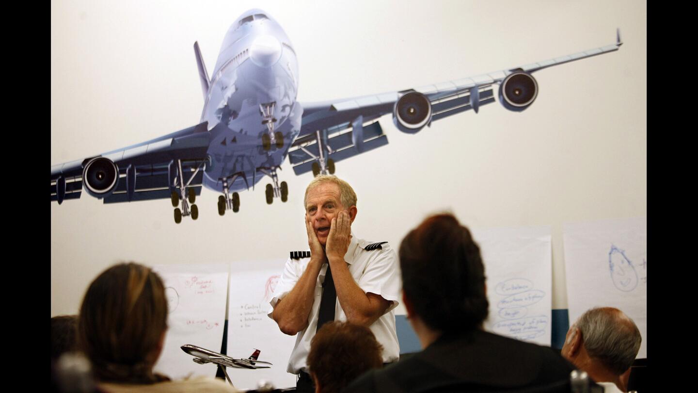 Captain Ron Nielsen gestures while conducting a fear of flying class at Air Hollywood. Nielsen retired after almost 40 years as a pilot for US Airways and teaches the flight classes once a month.