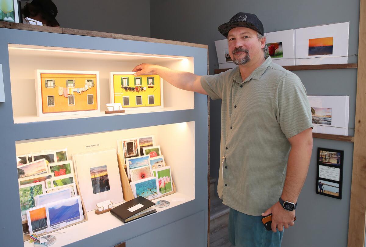 First-year photography exhibitor Steve Lerum shows an example of his more popular work at the Sawdust Art Festival.