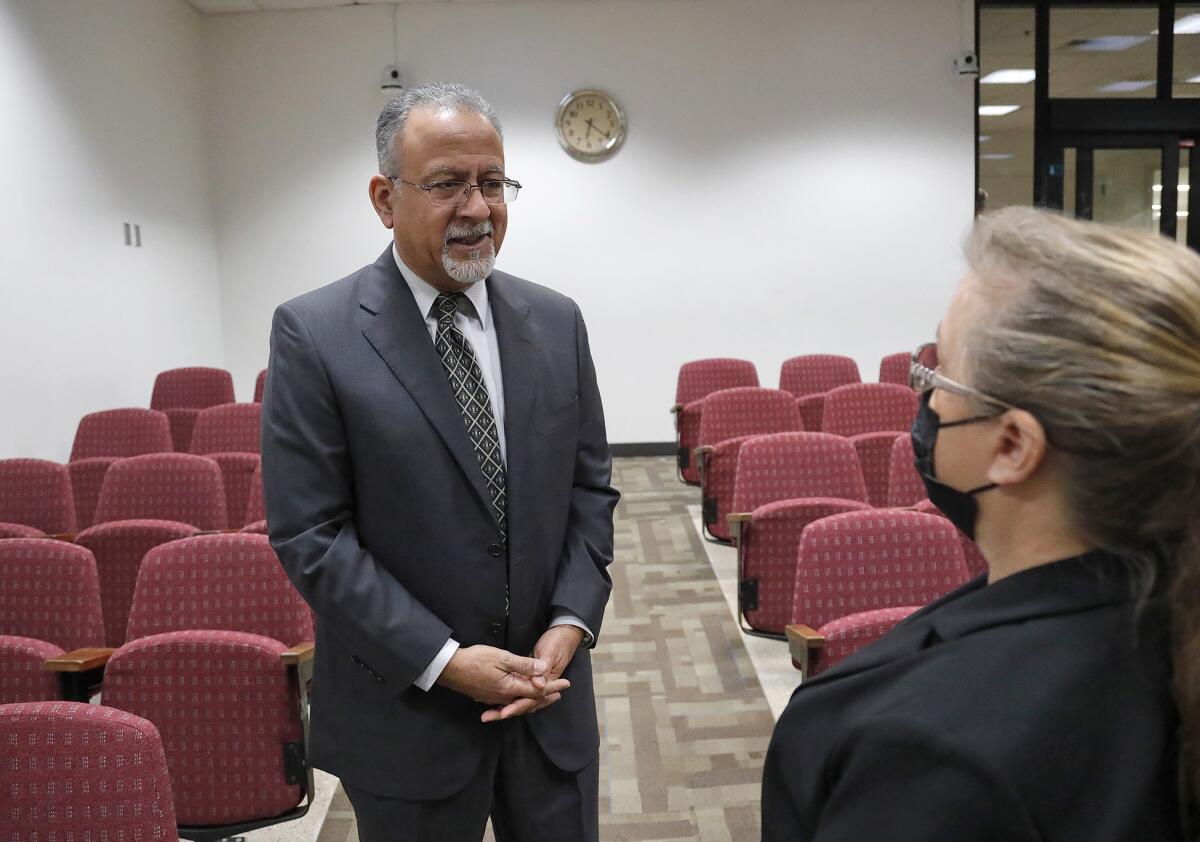 Raul Godinez II chats with Fountain Valley Mayor Pro Tem Kim Constantine after the City Council meeting on Tuesday.