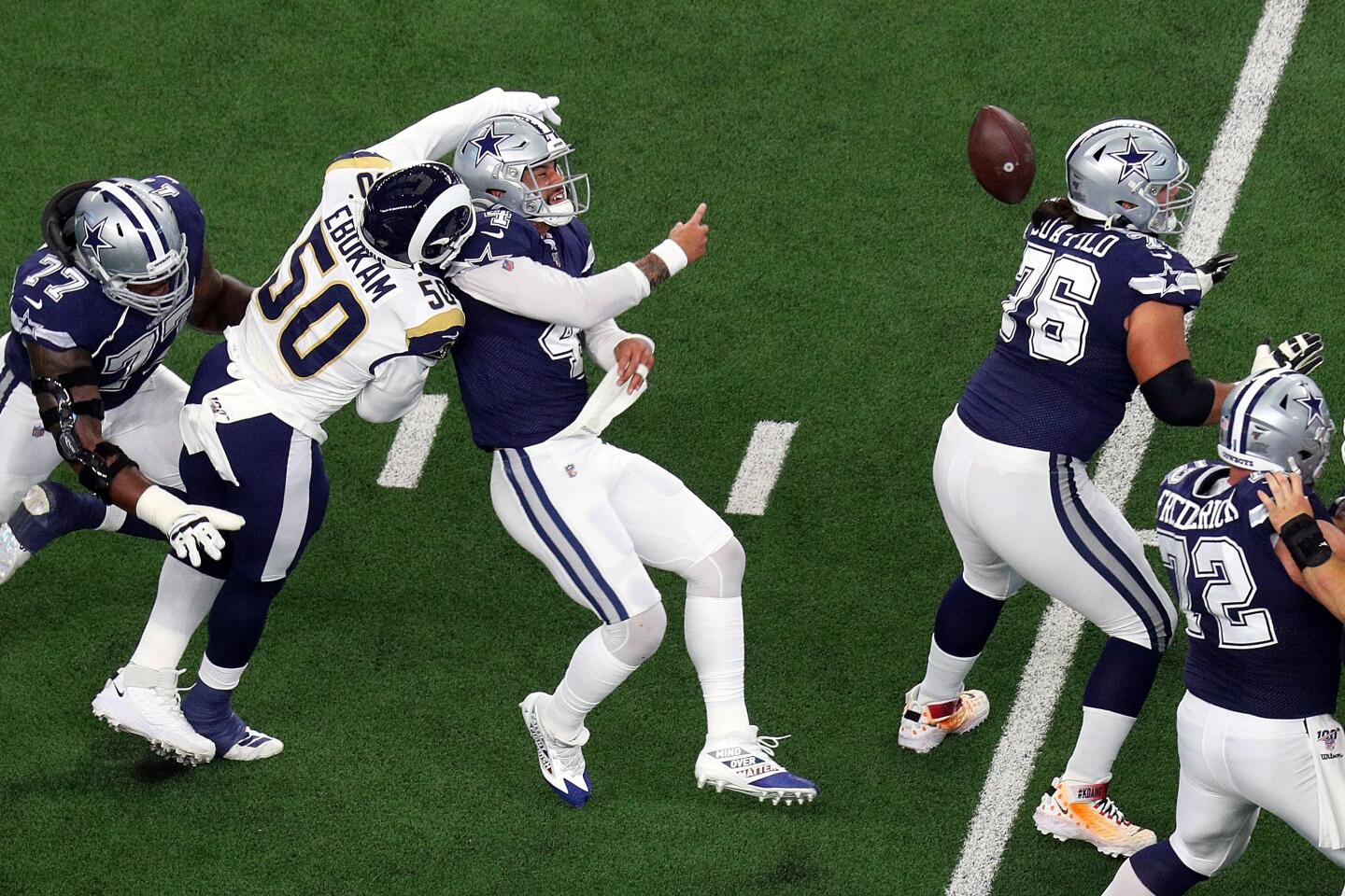 Rams linebacker Samson Ebukam, left, breaks up a pass by Dallas Cowboys quarterback Dak Prescott during the first quarter.
