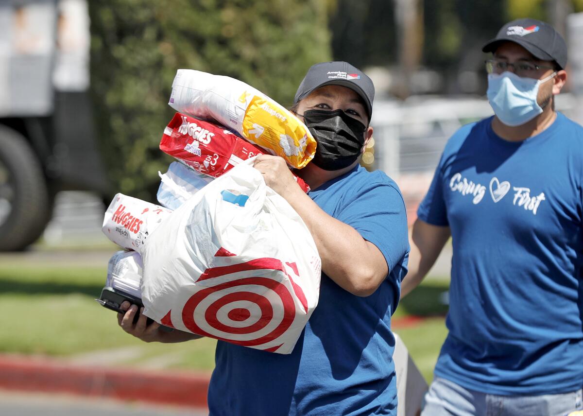 Volunteer groups unload diapers at the Christ Cathedral Church in Garden Grove on Friday.