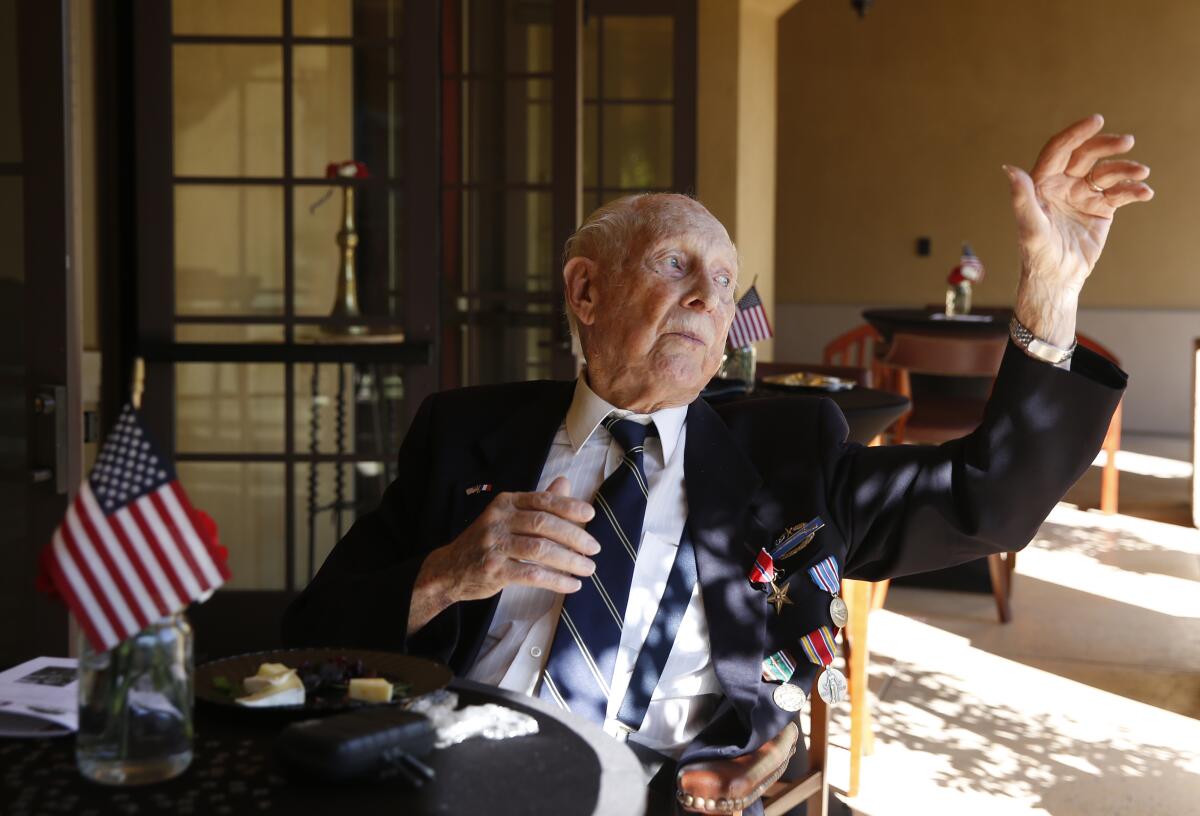 World War II veteran Eldon L. Knuth waves to friends after he was presented his Bronze Star