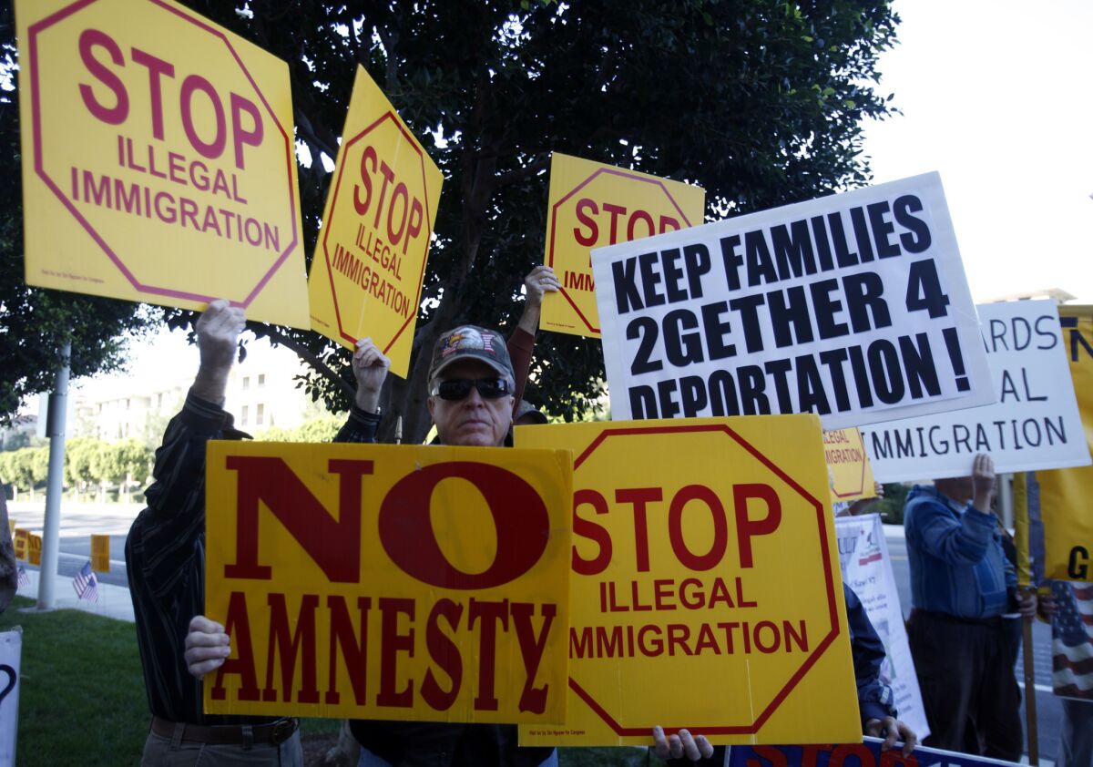 An anti-immigration group rallies in Irvine in 2013. John Tanton and his various groups have had a long presence in California's immigration debates