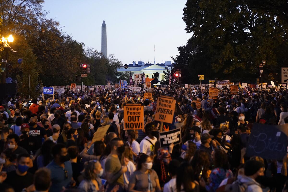 People celebrate in the streets outside the White House