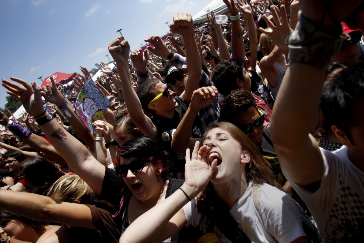 Rockelle Wilson sings along from the crowd as the band Less Than Jake performs during the Vans Warped Tour stop in August 2011 at Cal State Dominguez Hills.