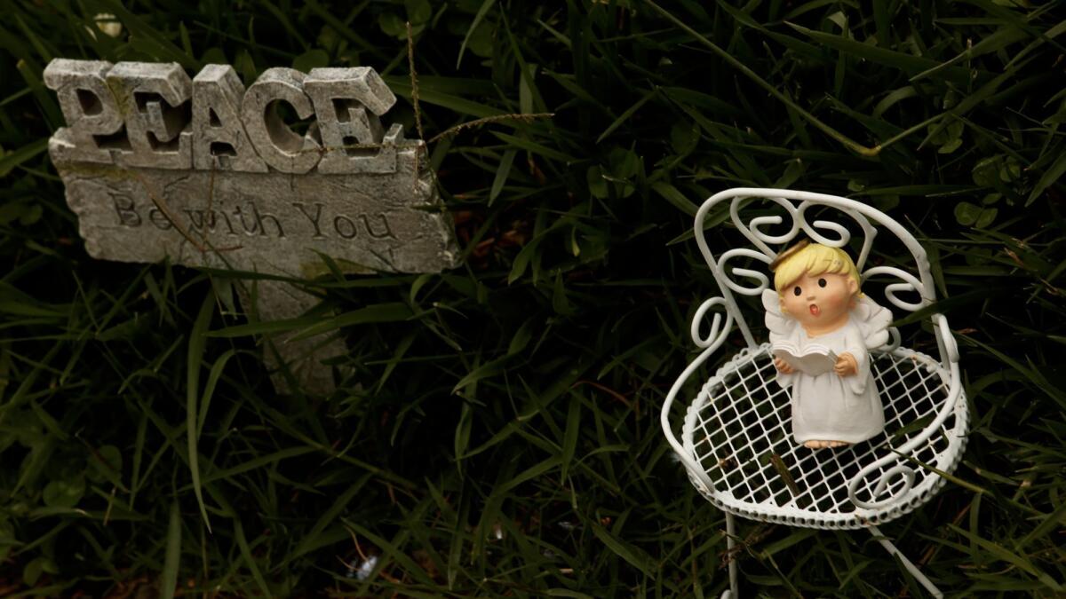 A small angel rests near the gravesite of Bree'Anna Guzman. (Genaro Molina / Los Angeles Times)