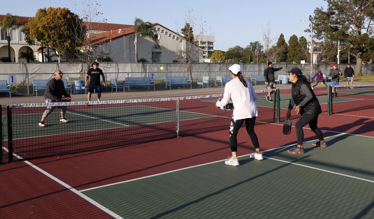 Players enjoy late afternoon pickleball on the courts at Worthy Park in Huntington Beach on Thursday.