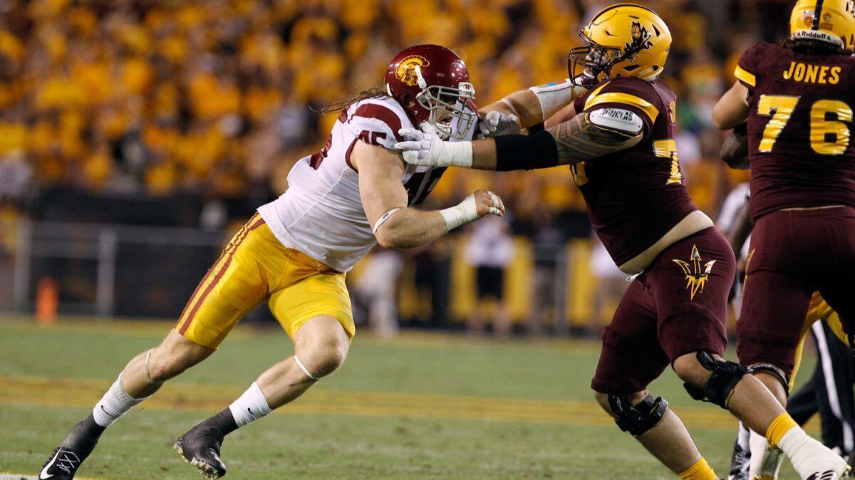 USC linebacker Porter Gustin (45) battles Arizona State offensive lineman Cohl Cabral during the second half on Saturday.