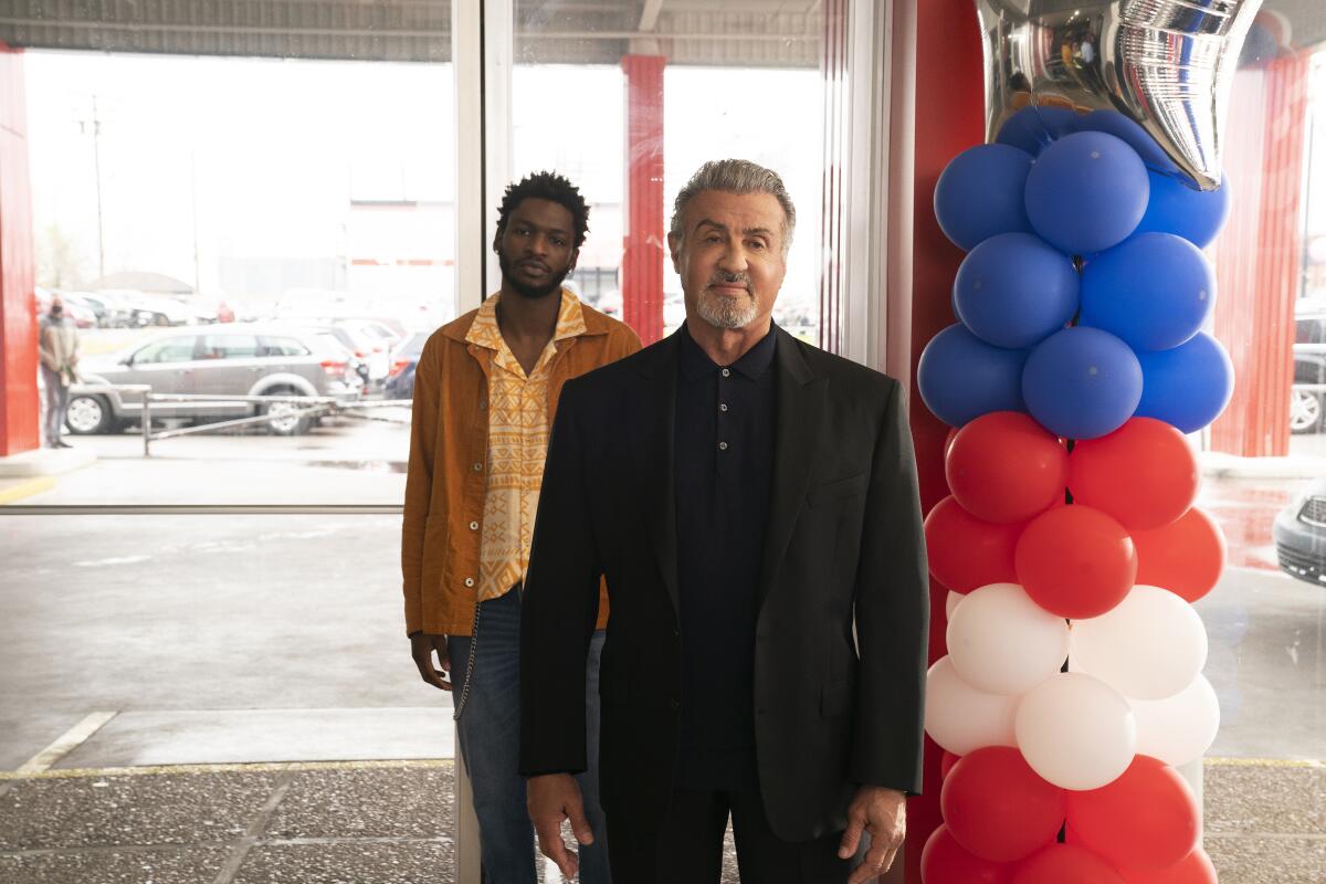 Two men standing in a car dealership