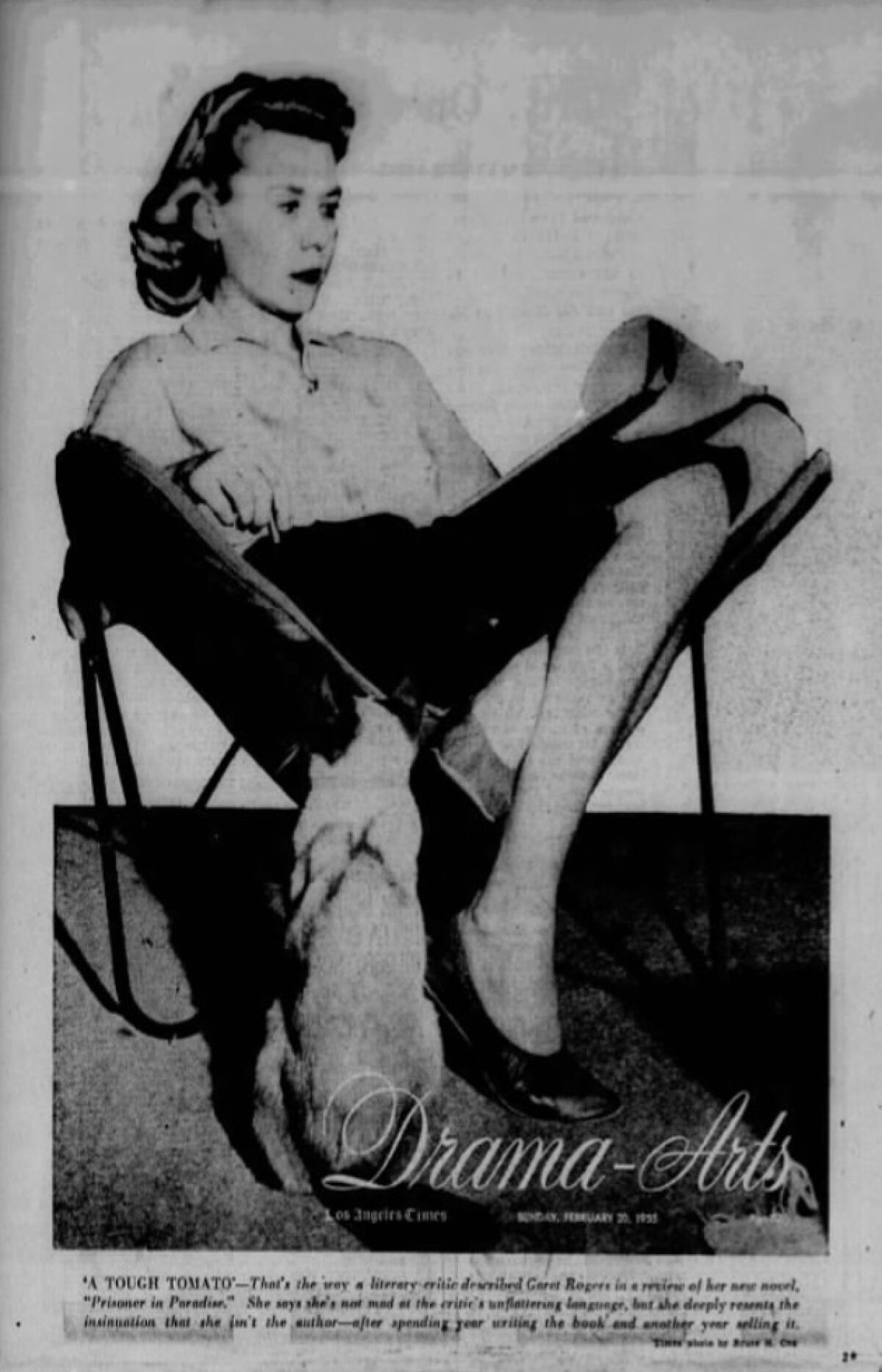 A seated Garet Rogers, with her cat at her feet