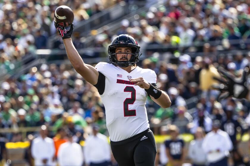 Northern Illinois quarterback Ethan Hampton throws a pass during an NCAA college football game against Notre Dame, Saturday, Sept. 7, 2024, in South Bend, Ind. (AP Photo/Michael Caterina)