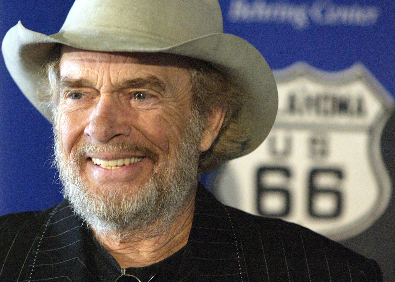 Merle Haggard smiles during a May 28, 2003, news conference at the National Museum of American History in Washington, where he and his sister Lillian Haggard Hoge donated belongings taken on their family's Dust Bowl-era move from Oklahoma to California.