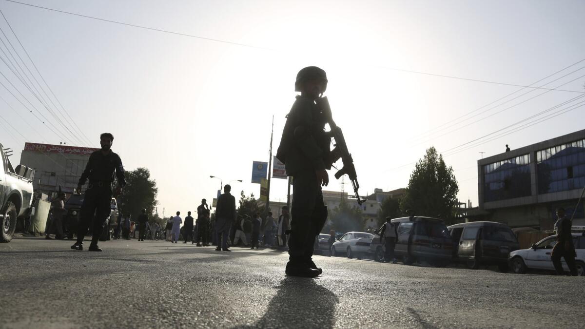 Security personnel arrive at the site of a deadly suicide bombing in western Kabul, Afghanistan.