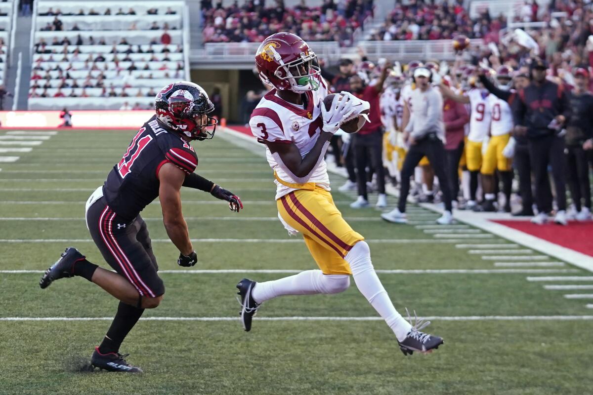 USC receiver Jordan Addison scores a touchdown against Utah safety R.J. Hubert. 