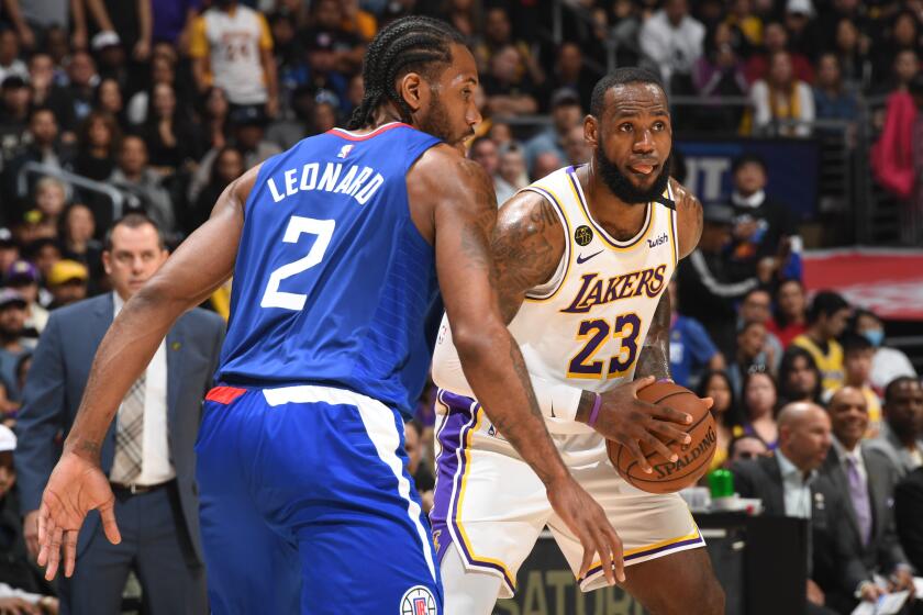 Clippers' Kawhi Leonard plays defense against Lakers' LeBron James on March 8 at Staples Center 