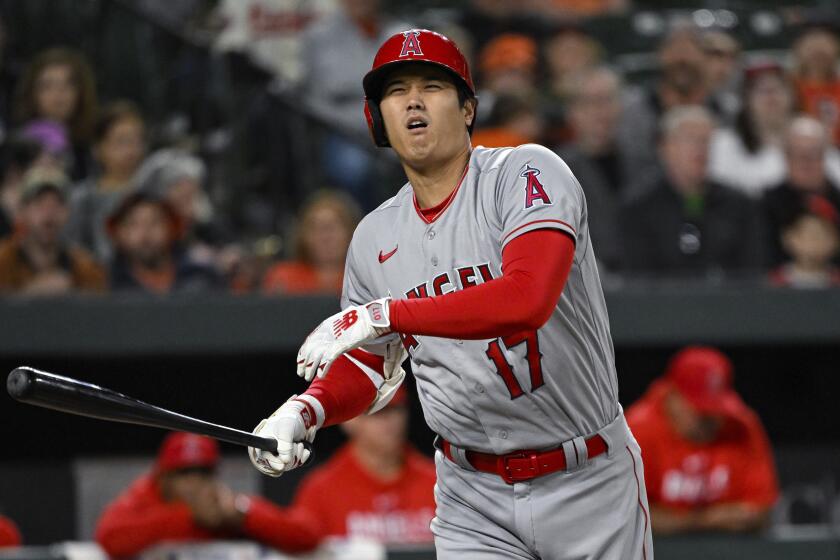 Los Angeles Angels' Shohei Ohtani (17) grimaces after swinging at a pitch thrown by Baltimore Orioles.