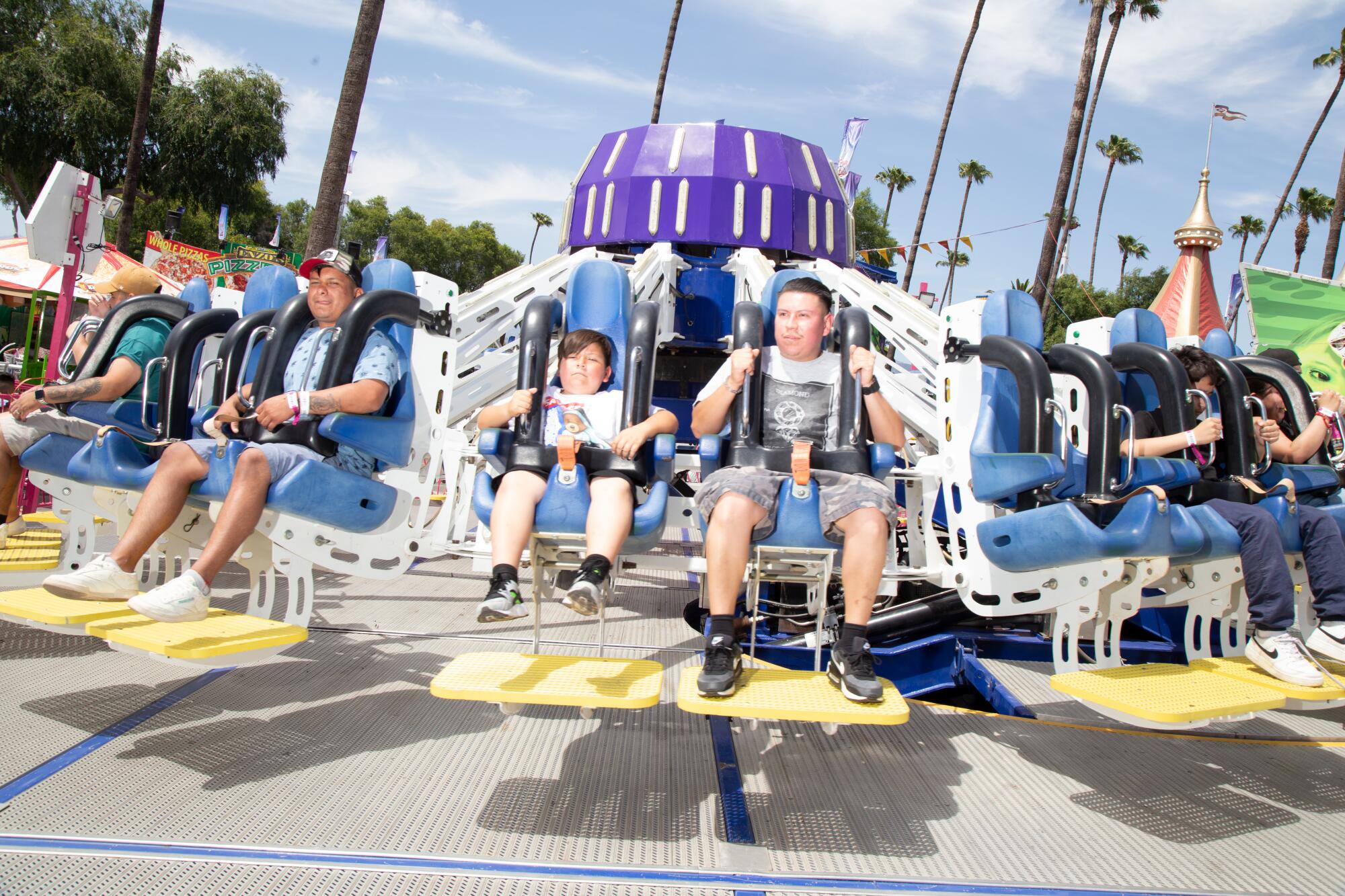 Fairgoers on amusement park rides at the Los Angeles County Fair.
