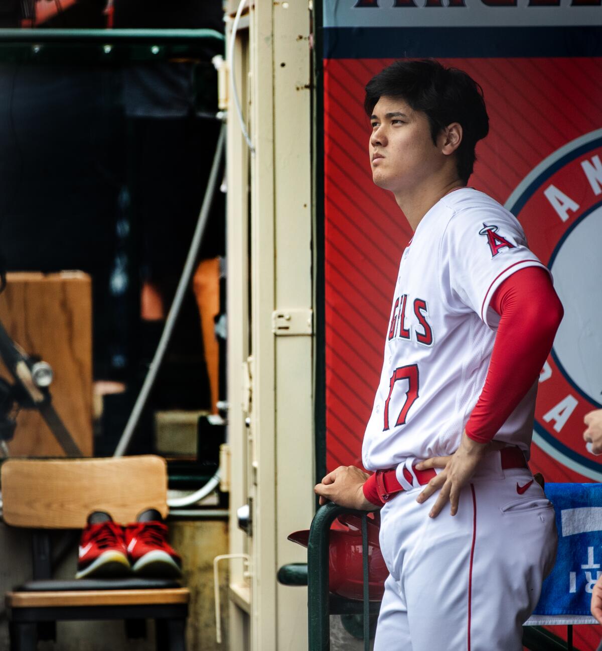 The Angels' Shohei Ohtani watches the top of the first inning from the dugout against the Pirates 