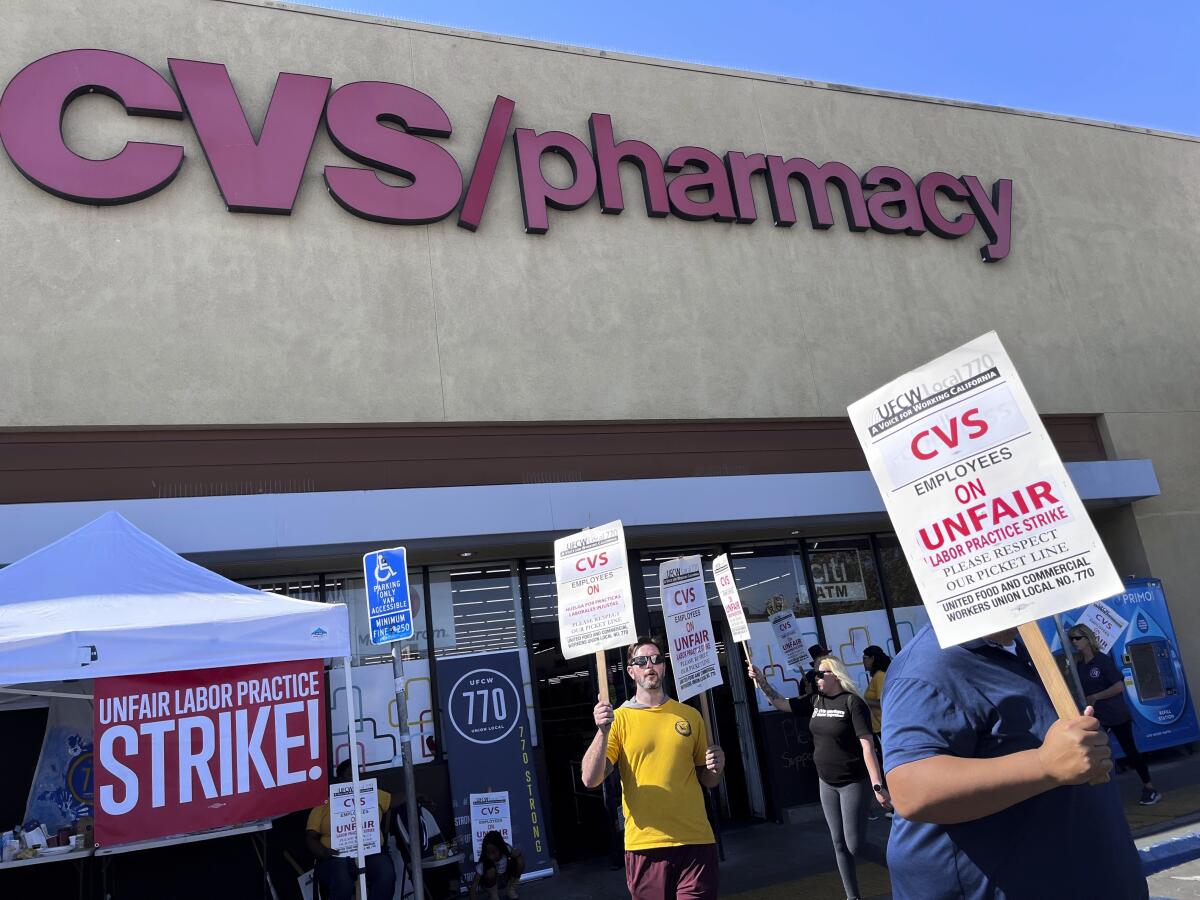 Workers on strike picket in front of a CVS pharmacy on Saturday in Los Angeles. 