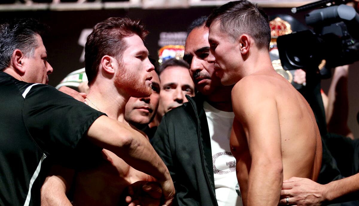 Canelo Alvarez, left, and Gennady Golovkin are separated after their face-off pose during their weigh-in Friday at T-Mobile Arena in Las Vegas.