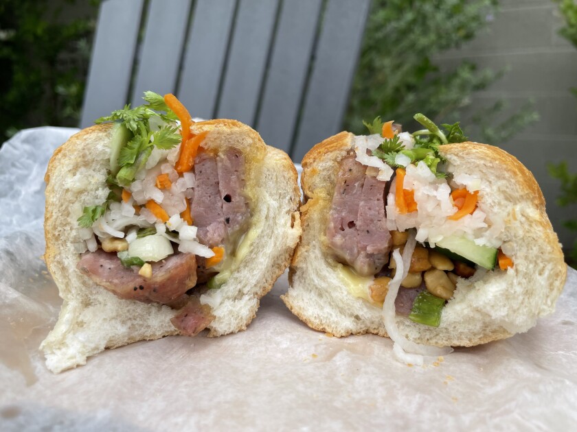 A banh mi sandwich cut in half.