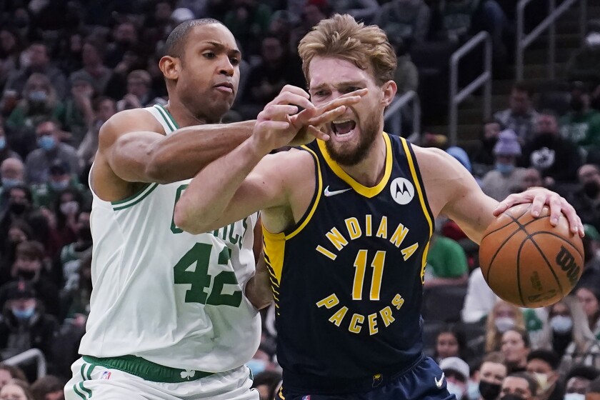Indiana Pacers forward Domantas Sabonis (11) tries to drive past Boston Celtics center Al Horford (42) during the second half of an NBA basketball game, Monday, Jan. 10, 2022, in Boston. (AP Photo/Charles Krupa)