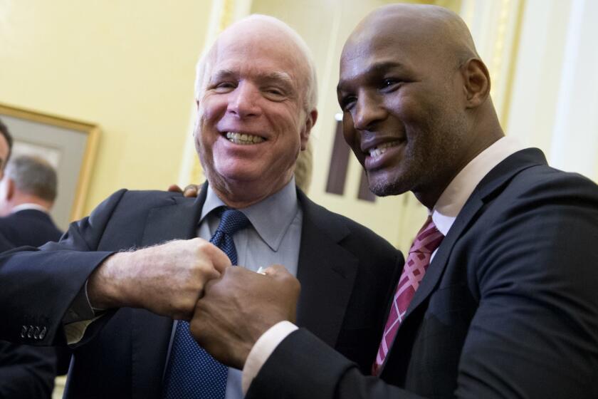 UNITED STATES - FEBRUARY 04: Sen. John McCain, R-Ariz., poses with boxer Bernard Hopkins, after a news conference in the Capitol on a study by the Cleveland Clinic Lou Ruvo Center for Brain Health in Las Vegason the effects of repeated blows to the head suffered by fighters.(Photo By Tom Williams/CQ Roll Call) (CQ Roll Call via AP Images)