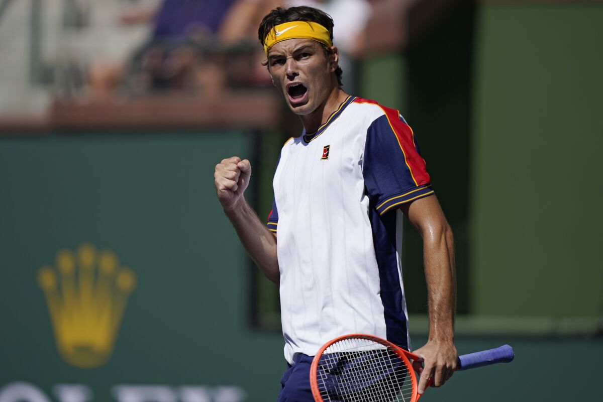 Taylor Fritz celebrates after winning a game against Matteo Berrettini, of Italy, at the BNP Paribas Open tennis tournament Tuesday, Oct. 12, 2021, in Indian Wells, Calif. (AP Photo/Mark J. Terrill)