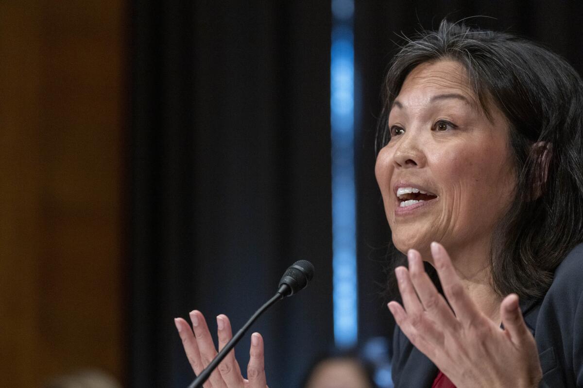 Julie Su speaks into a microphone during a Labor Secretary confirmation hearing