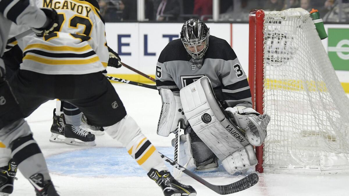 Kings goaltender Jack Campbell, right, stops a shot by Boston Bruins defenseman Charlie McAvoy during Saturday's game. If Campbell got injured in the game, emergency backup Steve Jakiel would have taken his place.