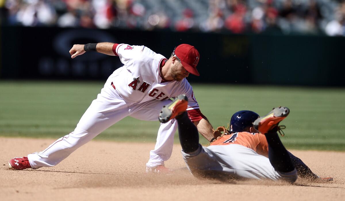 Angels second baseman Taylor Featherston, left, tags out Houston Astros' George Springer as he attempts to steal second during the seventh inning on Sunday.