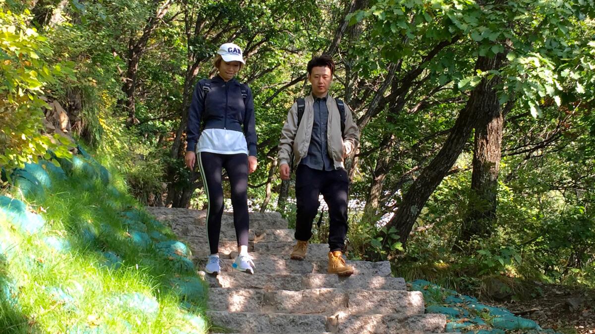 Wang Zhan and Fan Lei hike in Baihuashan National Nature Preserve in China.