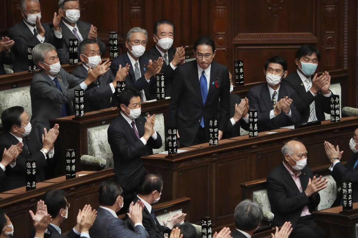 Fumio Kishida, center, is applauded after being elected as Japan's prime minister at the parliament's lower house Monday, Oct. 4, 2021, in Tokyo. Kishida was formally elected Monday as Japan's new prime minister in a parliamentary vote, replacing Yoshihide Suga. (AP Photo/Eugene Hoshiko)