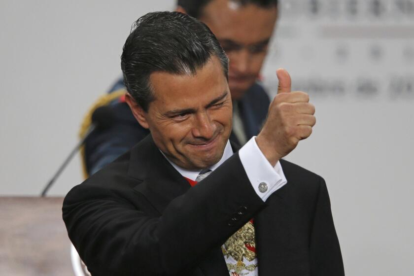 Mexico's President Enrique Pena Nieto gives a thumbs up as he gives his first state-of-the-nation address at Los Pinos presidential residence in Mexico City on Monday.