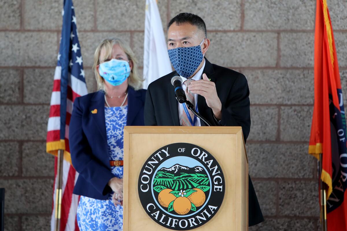 Dr. Clayton Chau, right, director of the Orange County Health Care Agency, answers questions.