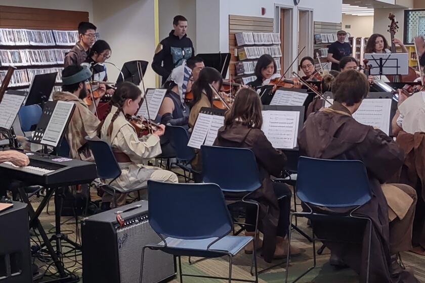 Conductor David Liu, right, leads Winecreek Ensemble musicians who played “Star Wars” tunes at the Poway Library on March 9.