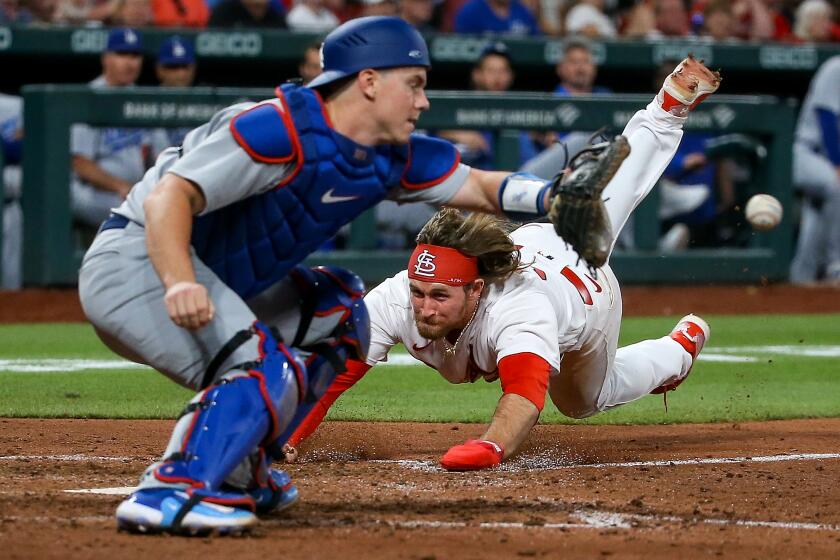 ST. LOUIS, MO - MAY 18: Brendan Donovan #33 of the St. Louis Cardinals scores a run ahead of the throw.