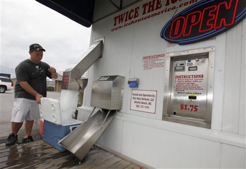 Lee Taylor, of Harlow, N.C., buys ice for his family to ride out the storm as Hurricane Earl heads toward the eastern coast in Atlantic Beach, N.C., Thursday, Sept. 2, 2010. (AP Photo/Chuck Burton)